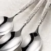 Silver carved spoon and white plate posed tableware set Application Scenario